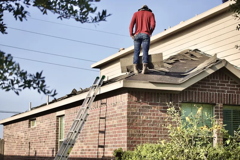 Professional roofer working on a residential roof in Fuquay